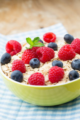 Oatmeal porridge with berries. Raspberries and blueberries.