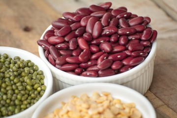 Mixed nuts in a bowl on a wooden background 
