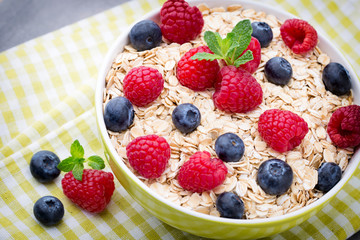 Oatmeal porridge with berries. Raspberries and blueberries.