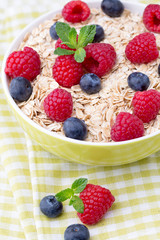 Oatmeal porridge with berries. Raspberries and blueberries.