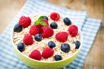 Oatmeal porridge with berries. Raspberries and blueberries.