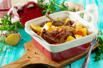 Roasted duck meat with boiled potatoes on a wooden table. Space