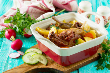 Roasted duck meat with boiled potatoes on a wooden table, select