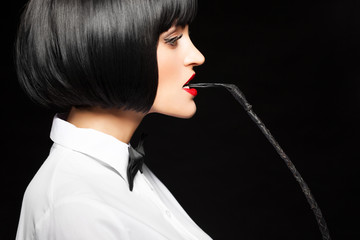 Sexy woman in wig bite whip