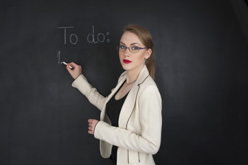 young successful business woman concept with copy space  on black chalk board in background