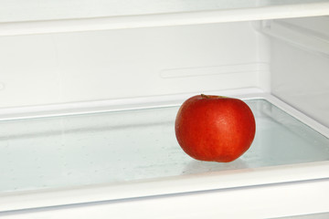Fresh red apple in domestic refrigerator.