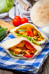 Fried chicken meat with vegetables in pita bread