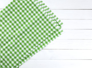 Green tablecloth on white wood table