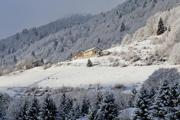 remote mountain village with the tops of snow-covered mountains