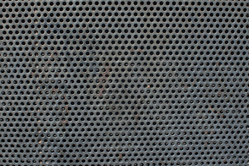 Corroded Metal grill with circular holes