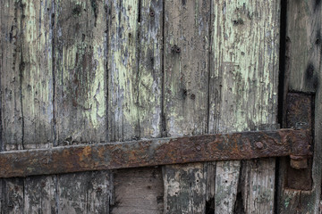 Rusty iron hinge on rotten wood