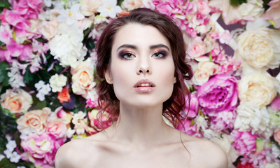 Portrait of beautiful fashion girl, sweet, sensual. Beautiful makeup and messy romantic hairstyle. Flowers background. Green eyes. 