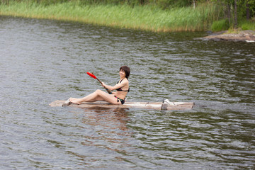 woman on a wooden raft