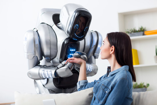 Robot holding hands of charming girl