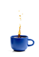 Splash of fresh coffee in the blue cup