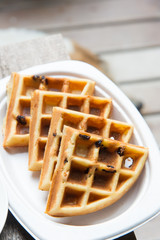 Tasty waffles on wood table