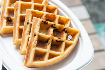 Tasty waffles on wood table