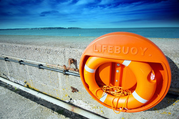 Orange life ring with yellow rope