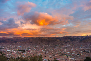 Cityscape of Cusco and cloudscape at dusk, Peru