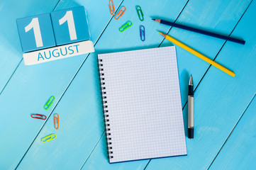 August 11th. Image of august 11 wooden color calendar on blue background. Summer day. Empty space for text