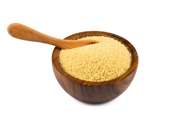 Raw couscous in a wooden bowl