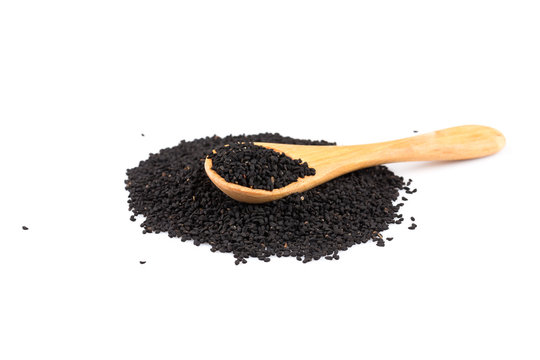 Heap of black sesame on wooden spoon