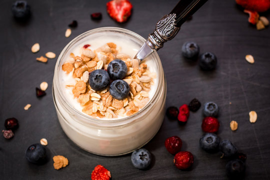 Healthy breakfast - yogurt with blueberries and muesli served in bank