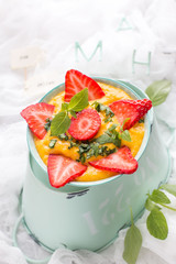Healthy mango rice dessert with fresh strawberries.