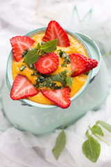 Mango rice pudding with strawberries.