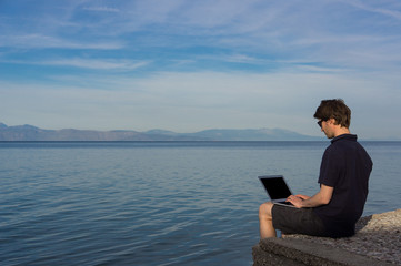 Man working on his laptop outdoors
