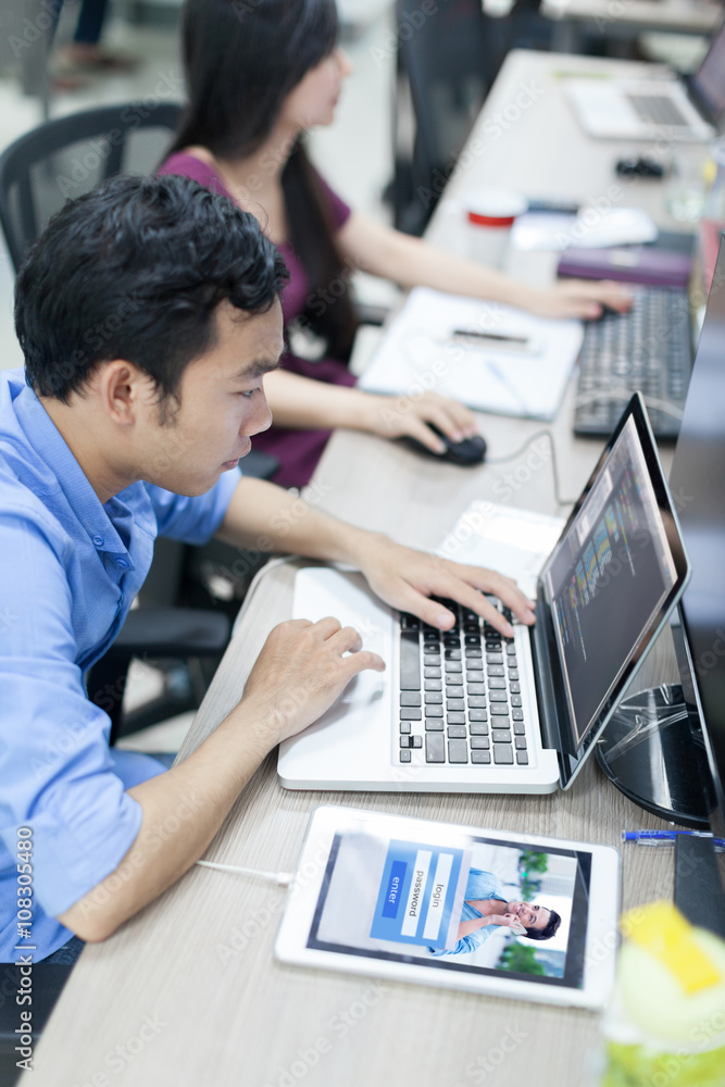 Poster asian software developer using laptop computer