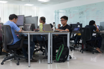 Fototapeta na wymiar Asian Businessman Sitting At Desk Working Laptop Computer