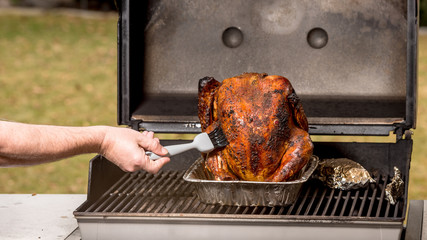 Basting a turkey on the BBq