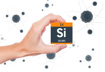 Silicon element symbol handheld and atoms floating in background