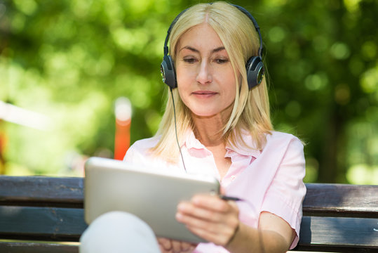 Mature woman listening music