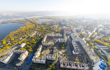 Aerial city view with crossroads, roads, houses, buildings, parks and parking lots, bridges. Copter shot. Panoramic image.