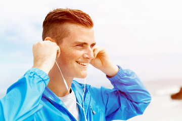 Sports and music. man getting ready for jogging