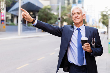 Businessman catching taxi in city