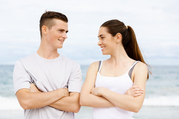 Young couple looking at each other on beach