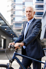 Fototapeta premium Successful businessman riding bicycle