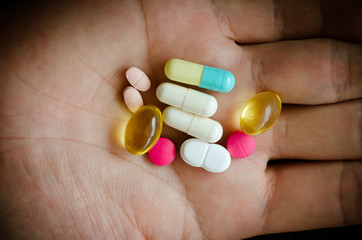 colored pills on hand