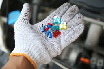 hand holding car repair tools in garage