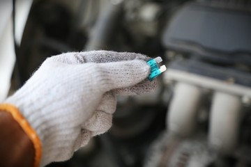 hand holding car repair tools in garage