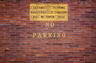 Restricted Parking No Parking Sign Painted on Brick Wall