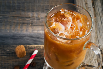 Coffee with ice in a glass, selective focus, space for text