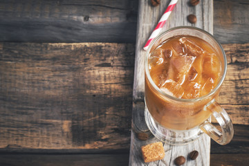 Coffee with ice in a glass, selective focus, top view, space for