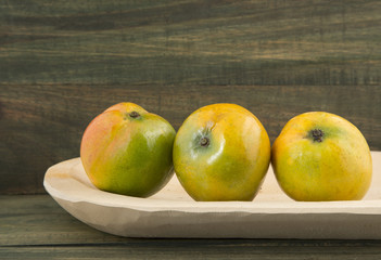 Mango tropical fruit on a wooden background