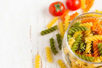 colorful italian fusilli pasta in a jar, selective focus, space