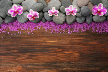 Obraz na płótnie Canvas Spa stones and orchid on wooden background