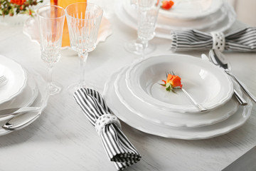 Served table with flowers in restaurant, closeup